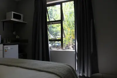 a bedroom with a bed and a large window at 31 at Murray in Pretoria