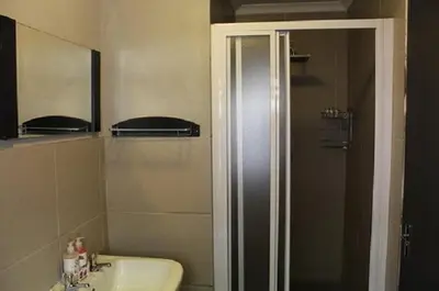 a bathroom with a shower and a sink at 31 at Murray in Pretoria