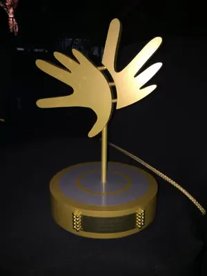 a gold trophy with a reindeer on a table at La Lechere Guest House in Phalaborwa