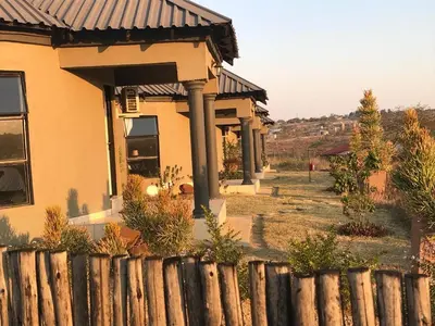a house with a fence in front of it at Rhurhy Guest House in Acornhoek