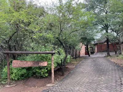 a sign in a park with a brick road at Hakuna Matata in Marloth Park