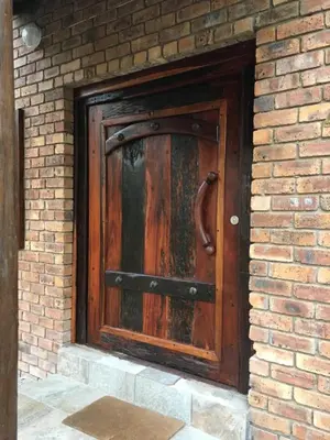 a large wooden door in a brick wall at Hakuna Matata in Marloth Park