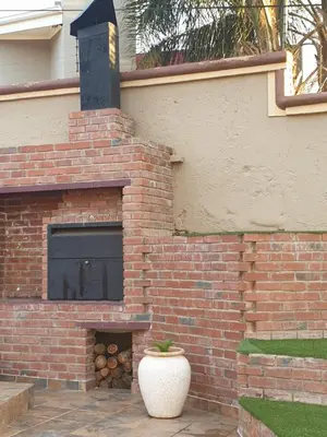 a brick oven with a pot in front of it at LANGA 'S COZY GUESTHOUSE in Pretoria