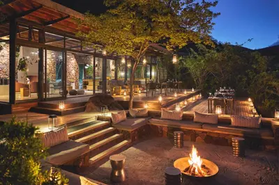 a patio with benches and a fire pit at Marataba Mountain Lodge in Kransberg