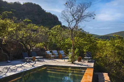 a swimming pool with a view of a mountain at Marataba Mountain Lodge in Kransberg