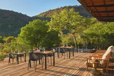 a group of tables and chairs on a deck at Marataba Mountain Lodge in Kransberg