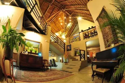a large lobby with a grand piano in a building at Utopia in Africa Guest Villa in Nelspruit