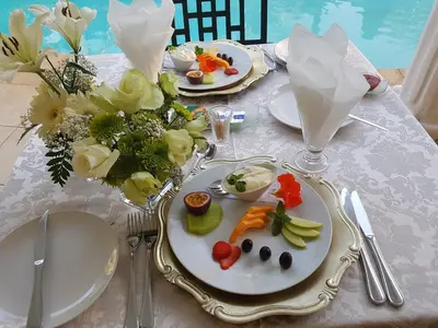 a table with plates of food on top of it at La Barune Guest House in Tzaneen