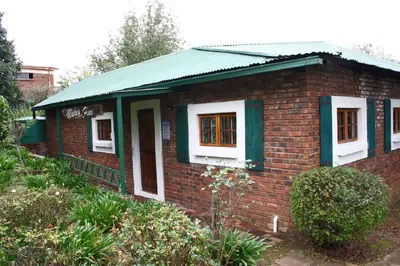 a small brick house with a green roof at Mickey Finn in Dullstroom
