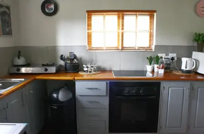 a kitchen with a sink and a black dishwasher at Mickey Finn in Dullstroom
