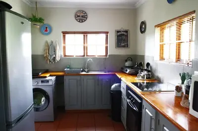 a kitchen with a washing machine and a washer at Mickey Finn in Dullstroom