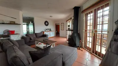a living room with a couch and a table at Mickey Finn in Dullstroom
