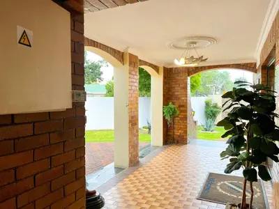 a hallway of a house with a brick wall at Aerodrome Lodge and Conference Centre in Benoni