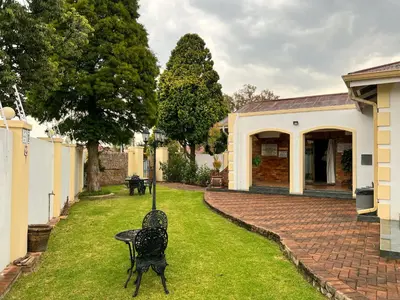 a chair in the yard of a house at Aerodrome Lodge and Conference Centre in Benoni