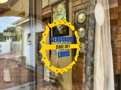 a yellow sign on the door of a store at Aerodrome Lodge and Conference Centre in Benoni