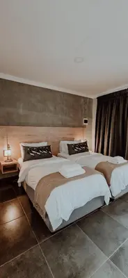 a large bedroom with two beds in it at Livingwaters Self-Catering Accommodation in Ermelo