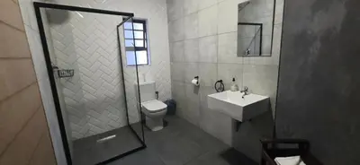 a bathroom with a shower and a toilet and a sink at Livingwaters Self-Catering Accommodation in Ermelo