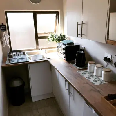 a kitchen with a counter and a sink and a window at Livingwaters Self-Catering Accommodation in Ermelo