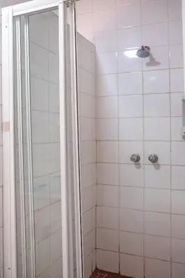 a shower with a glass door in a bathroom at Owl House Marloth Park in Marloth Park