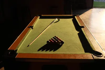 a pool table with a cue ball on it at Lions Rock Rapids - Luxury Tented Camp in Hazyview