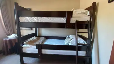a couple of bunk beds in a room at Aviemore Lodge in Dullstroom