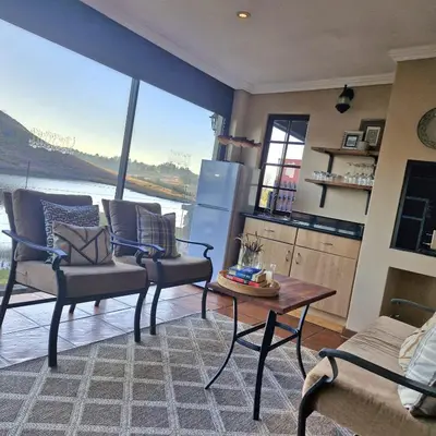 a kitchen with a large view of the water at Aviemore Lodge in Dullstroom