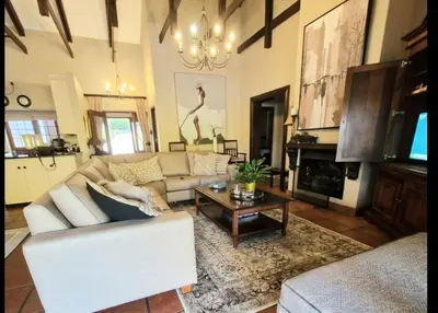 a living room with a couch and a coffee table at Aviemore Lodge in Dullstroom