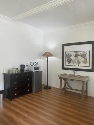 a living room with a table and a lamp at White River B & B in White River