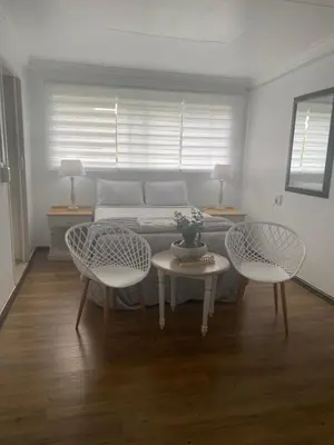 a room with a bed and two chairs and a table at White River B & B in White River