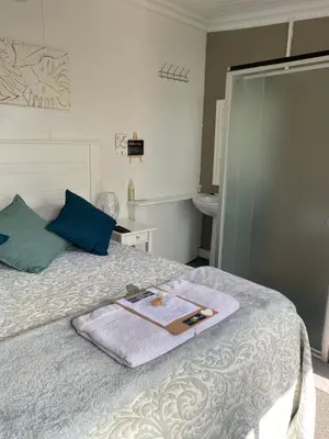 a bedroom with a bed with a book on it at White River B & B in White River