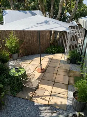 a patio with a table and an umbrella at White River B & B in White River