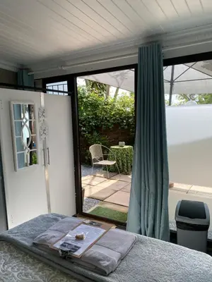a room with a bed and a sliding glass door at White River B & B in White River