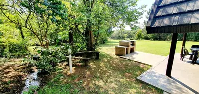 a backyard with a picnic table and a bench at Wild Forest Inn in Graskop