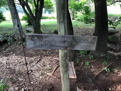 a sign that says idiots club house in a park at Tegwaan Country Getaway in Waterval Boven