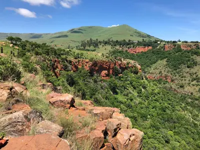 a view of a mountain with trees and rocks at Tegwaan Country Getaway in Waterval Boven