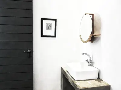 a bathroom with a sink and a mirror at Ochre House in Marloth Park