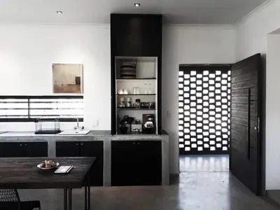 a kitchen with a table and a counter top at Ochre House in Marloth Park