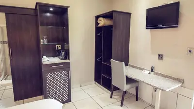 a room with a bathroom with a sink and a toilet at Machauka Lodge in Lephalale