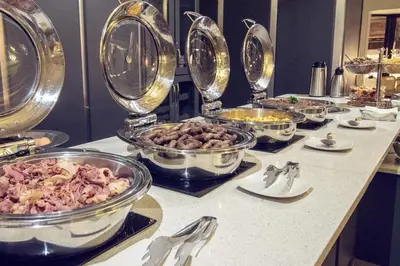 a buffet with many bowls of food on a counter at Machauka Lodge in Lephalale