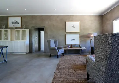 a living room with two chairs and a table at Nextdoor Kruger in Marloth Park