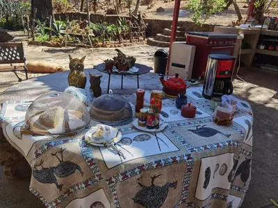 a table with a table cloth with food on it at Bosveldsig Cottages in Modimolle