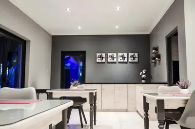 a dining room with two tables and chairs at Cascades Guest Lodge in Nelspruit