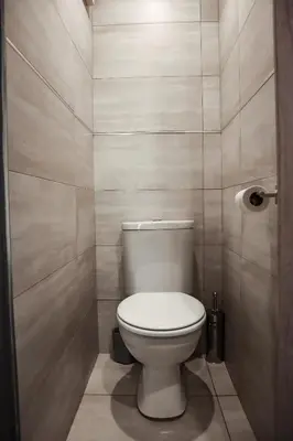 a bathroom with a white toilet in a room at Cascades Guest Lodge in Nelspruit