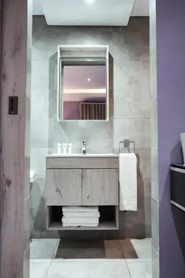 a bathroom with a sink and a mirror at Cascades Guest Lodge in Nelspruit