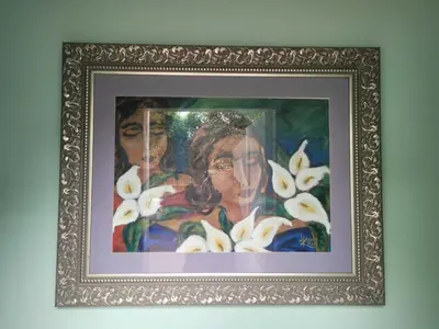a painting of two women with white flowers in a frame at Arum Lily Guest Rooms in Pretoria