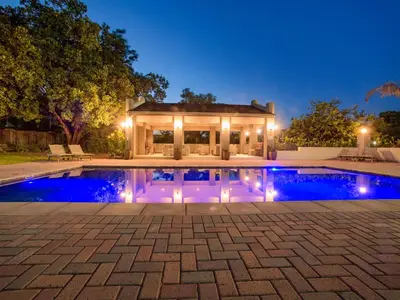 a swimming pool in front of a house at night at Monkey Thorn Lodge & Wellness Spa - Adults Only in White River
