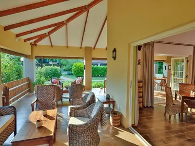a living room with chairs and a table at Monkey Thorn Lodge & Wellness Spa - Adults Only in White River