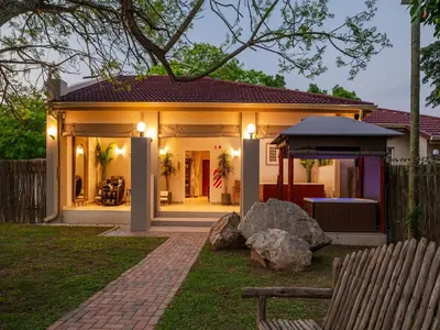 a house with lights on the front of it at Monkey Thorn Lodge & Wellness Spa - Adults Only in White River