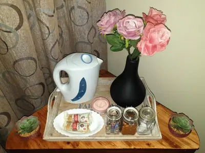 a tray with a vase and flowers on a table at SnL 38 Hoep Hoep in Malelane
