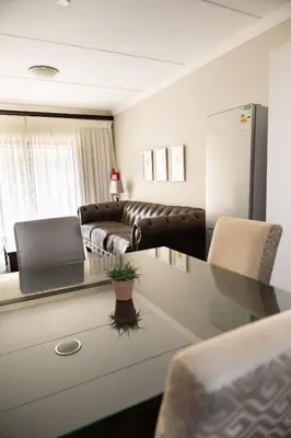 a living room with a couch and a table at Kyalami Creek in Midrand